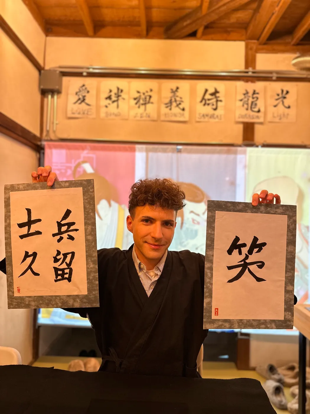 A guest holding up his finished works